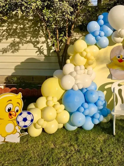 A close-up of the duckling balloon arch and the soccer-playing duckling prop, showcasing the fun details of the setup.