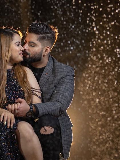 An intimate and cozy pre-wedding shot by a bonfire at night, capturing the warmth and romance of the moment.