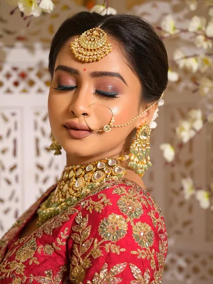 Another beautiful close-up with eyes closed, emphasizing the artistry of the eye makeup. The shimmering lids and perfectly defined lashes are key components of this classic Desi bride look.