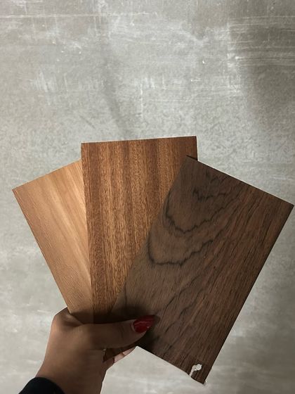 The design process begins with materials. These wood veneer samples were the foundation for 'The Terra Office', selected for their rich brown hues and timeless, earthy charm.