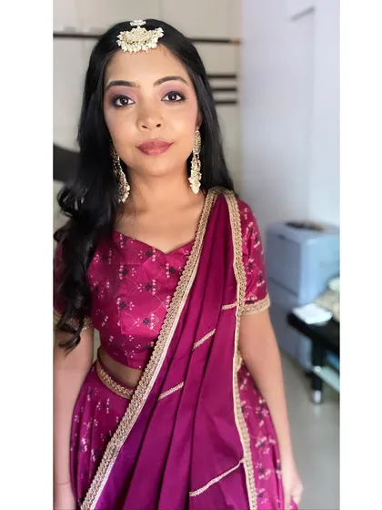 A pretty and youthful look for this client. The soft pink makeup and statement jewelry are a perfect combination.