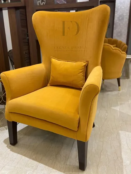 A set of two high-back armchairs in a sunny yellow velvet. Their simple, elegant silhouette and vibrant color make them a cheerful and stylish addition to any living space.