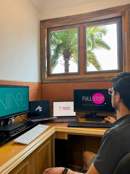 A look at my other side: entrepreneur by day, DJ by night. This is my workstation where I manage my businesses, with logos for Niine Artist and Full Stop Entertainment on the screens.