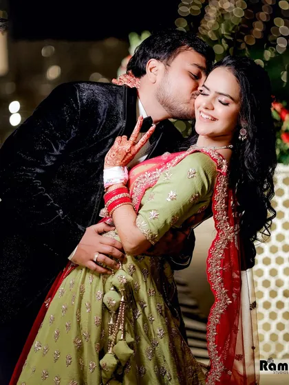 A playful and affectionate candid moment from a ring ceremony. The groom's kiss on the cheek and the bride's joyful expression perfectly capture the spirit of the celebration.