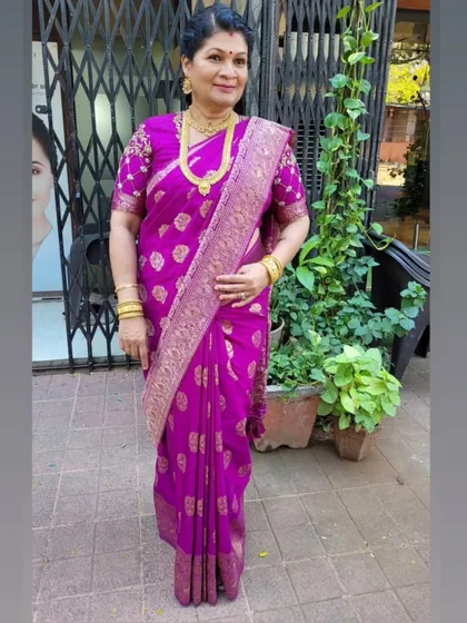 My favorite muse, my teacher. It is always an honor to drape her, and this time it was in a beautiful purple silk saree with an embroidered blouse.