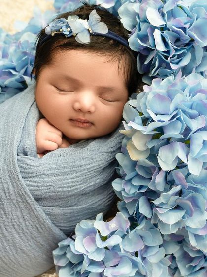 This little one takes my heart away. A classic swaddled pose surrounded by a bed of blue hydrangeas creates a portrait that is both simple and breathtakingly beautiful.