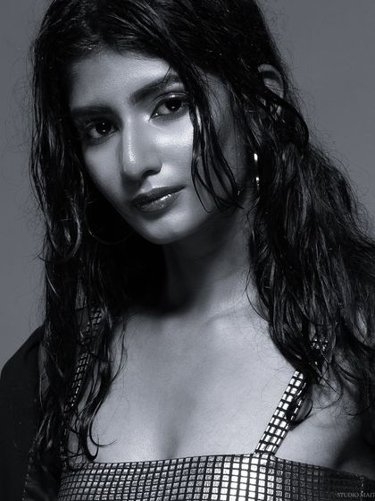 A black and white close-up from the "wet look" series, with a direct and engaging gaze.