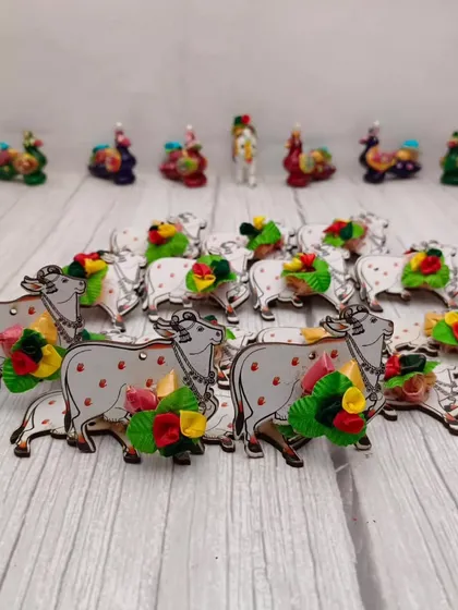 A Haldi Kumkum set featuring cow-shaped holders, a traditional and charming option for festive return gifting.