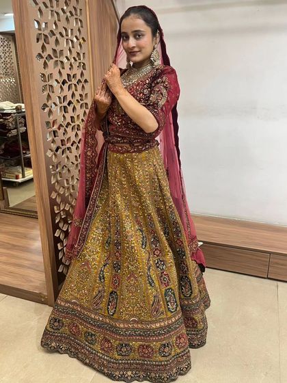 The rich fabrics and detailed embroidery make this bridal lehenga a stunning choice for your wedding day.