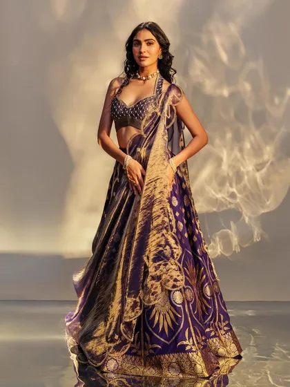 A look from a campaign celebrating 'Made in India'. This stunning purple Benarasi lehenga paired with a modern blouse and pearl jewelry is perfect for the contemporary Indian woman.