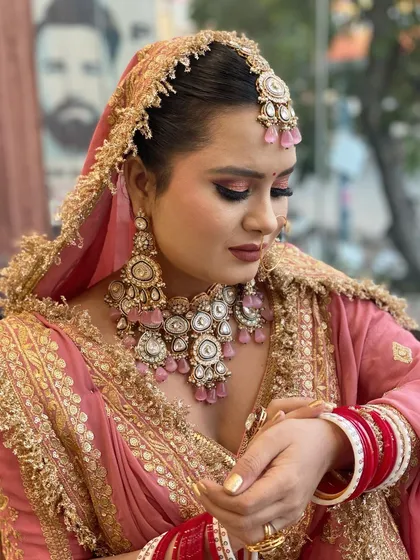 A closer look at this stunning bride in her pink and gold lehenga. I gave her a classic golden nail polish on her extensions to perfectly match the intricate work on her outfit. Bridal nails are the final touch that completes the entire look.