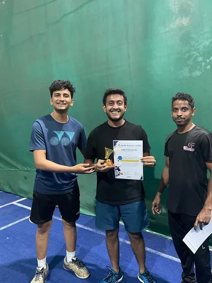 A proud moment for our adult badminton tournament winner, receiving his trophy and certificate from our coach. Congratulations on a well deserved victory.