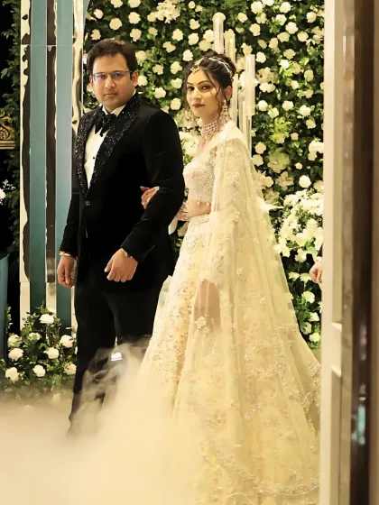 Another shot of the couple's grand entrance, with dramatic smoke. The bride's makeup remains flawless and radiant.