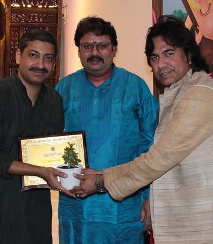 A group photograph capturing the camaraderie between artists after a successful baithak.