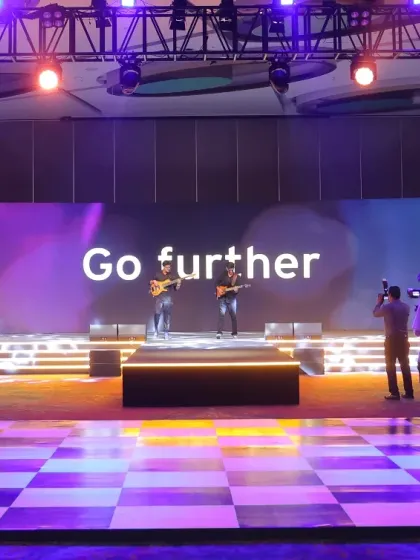 A wide shot of the stage setup for a musician flashmob, showing how we integrate the performance with the event's branding and messaging on the main screen.