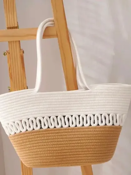 The clean lines and neutral colors of this rope tote bag make it a versatile accessory that complements any outfit.
