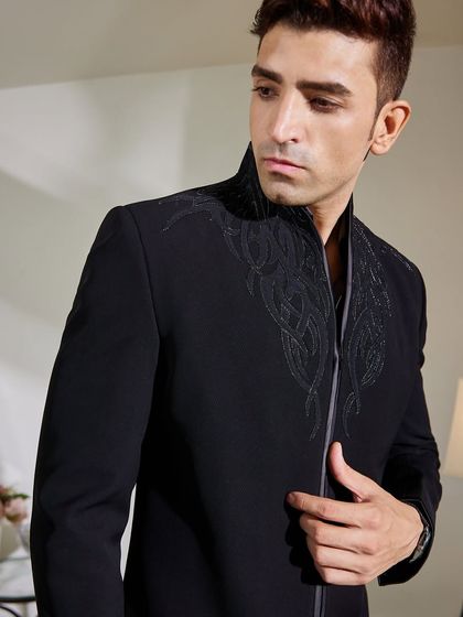 A detailed shot focusing on the zipper and the fine embroidery. These modern elements are seamlessly integrated to elevate the entire garment.