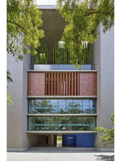 The facade of the School of Arts and Sciences at Ahmedabad University demonstrates our approach to climate-responsive design. The integration of terracotta louvers, extensive glazing, and verdant rooftop gardens creates a building that breathes, connecting the interior learning environments with the natural landscape.