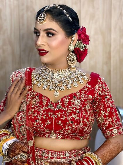 A beautiful close-up of my bride. I love how the red roses in her hair bun match her stunning red lehenga and bold lipstick.