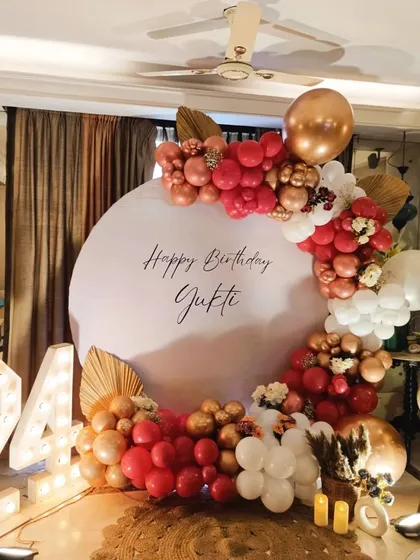 A slightly different angle of the chic 24th birthday home decoration. The large light-up marquee numbers and warm candles on the floor add to the celebratory and sophisticated ambiance.