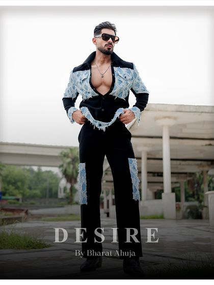 A full-body shot that commands attention. The denim-fringed suit redefines menswear with its edgy elegance and fearless charisma.