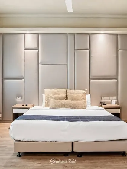 Another view of the hotel room, showing the TV and seating area. The design is clean, contemporary, and focused on providing a comfortable and functional stay for guests.