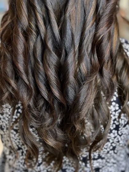 A close-up of the tightly defined curls, showcasing the texture and color.