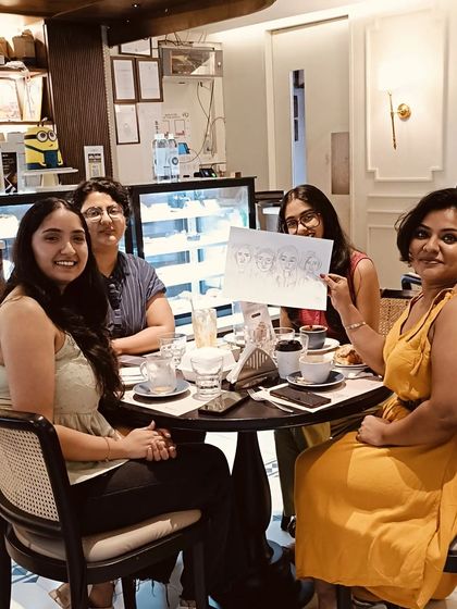 A candid shot of a group of friends posing with their new caricature. It's all about capturing those happy, shared moments.