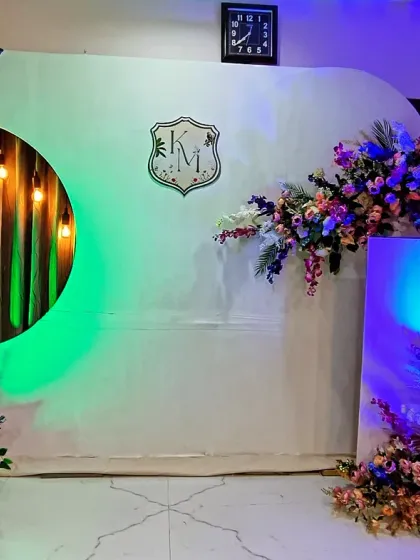 The same modern engagement backdrop, shown here with colorful mood lighting in green and blue to completely change the vibe for the evening party.