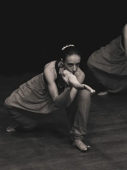 A close-up of two performers during "SAMVIT". The practice involves deep connection and awareness between the artists.