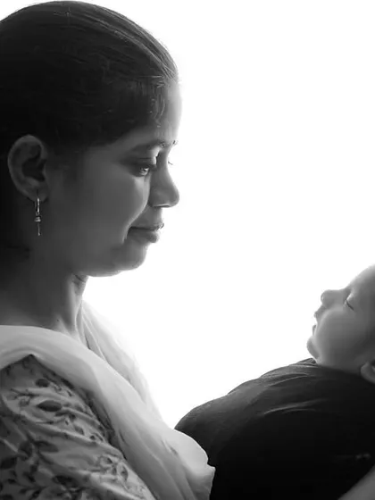 Another beautiful high-contrast, black and white portrait of a mother admiring her newborn. These minimalist shots focus purely on the emotion and connection.