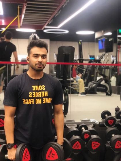 Getting ready for a session with dumbbell curls. Building strong arms is a key part of a balanced physique.