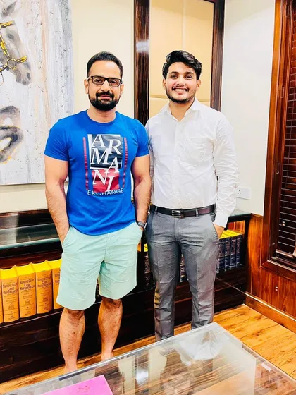 Standing with a mentee in my office. My role is to provide a stable and supportive presence as they navigate their careers.
