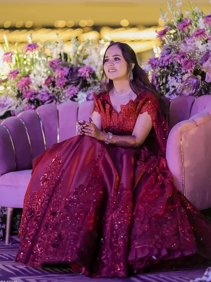 A candid moment of the bride enjoying her Sangeet. Her makeup looks fresh and glamorous, even under the stage lights.