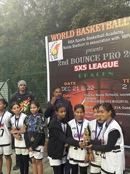 The U-12 girls' team receiving their championship trophy. We are proud to develop strong female athletes.