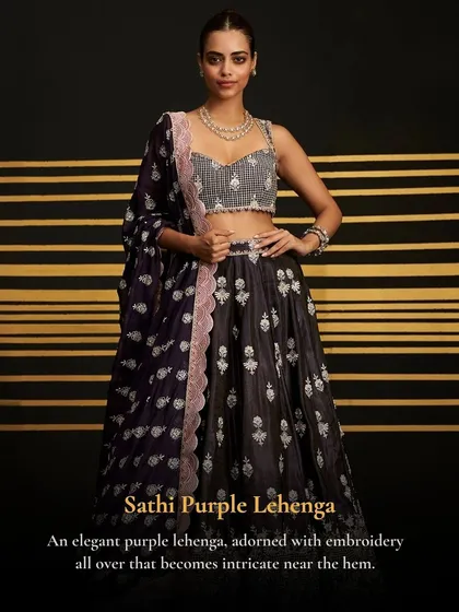 The Sathi Purple Lehenga is an elegant choice for a cocktail night or reception. The intricate embroidery on the dark base is simply stunning.