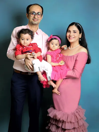 A classic family portrait with one-year-old twins. This studio shot is perfect for capturing a formal but happy memory of this special milestone.