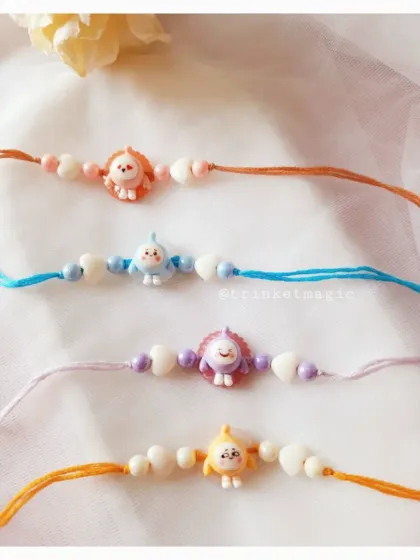 Another look at my tiny cartoon Rakhis. The pastel colors and cute animal-like characters make them a sweet and simple choice for toddlers and babies.