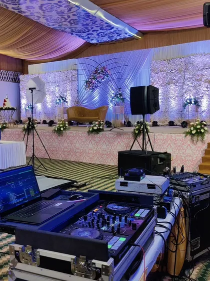 The view from the DJ booth, showing the beautifully decorated stage and reception hall. I work from all angles to ensure the event's technical aspects and overall flow are perfectly synchronized.