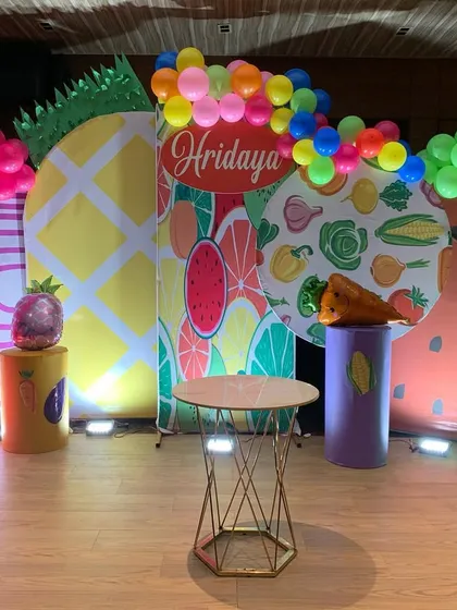 A unique and colorful 'Fruits and Vegetables' theme for a birthday party. We used large, custom printed backdrops and balloon arrangements to create a fun and healthy vibe.
