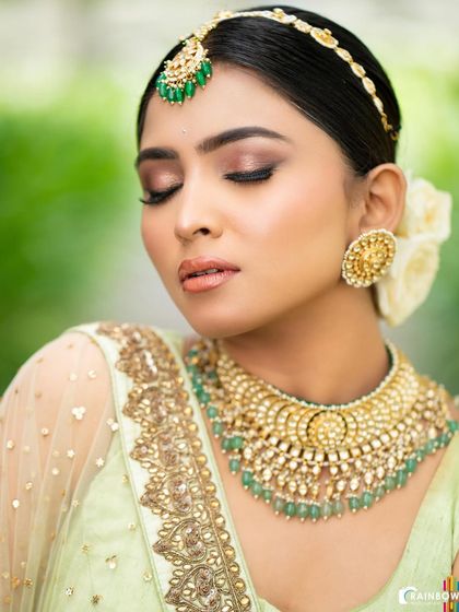A close-up beauty shot focusing on the flawless makeup and intricate jewelry. This type of shot is perfect for makeup artists' portfolios or jewelry brands.