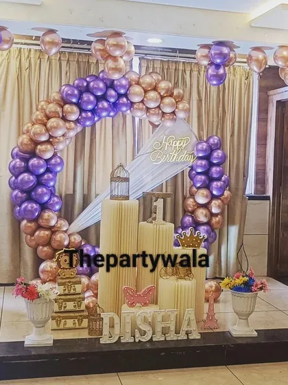 A glamorous ring decoration with purple and rose gold chrome balloons. This setup is perfect for a big celebration in a banquet hall.