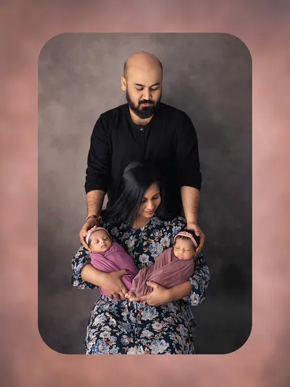 A creative and intimate family portrait with twins. This pose beautifully symbolizes the parents as the foundation of their new family.