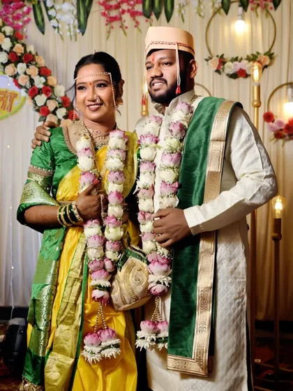 A formal portrait of the wedding couple. The bride's makeup is perfectly balanced, ensuring she looks glamorous without being overdone.