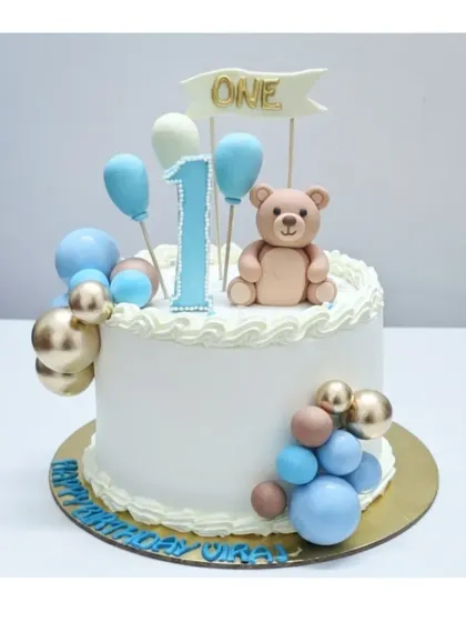 A classic first birthday cake with a fresh fruits flavor. This design features a sweet teddy bear, balloon decorations, and a simple, elegant finish.