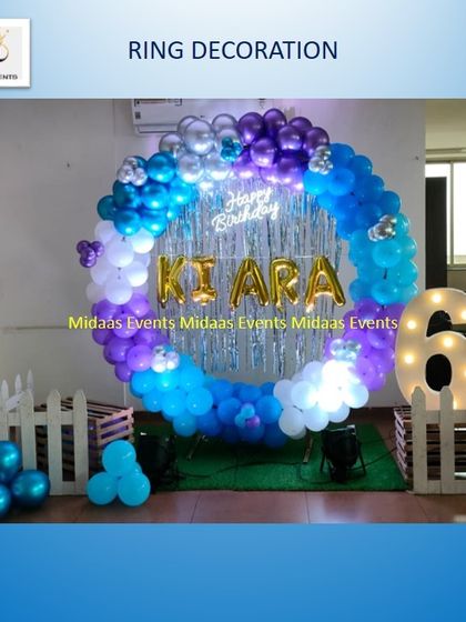 A full view of the ring decoration for the 6th birthday party, showing the tinsel backdrop and the small white picket fences that complete the look.