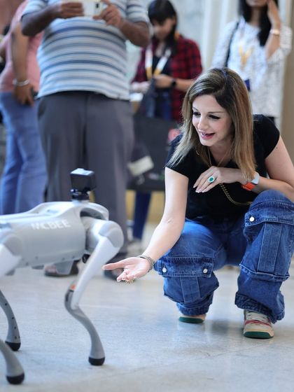 A memorable moment as Sussanne Khan interacts with a robotic dog, showcasing the fun and futuristic side of the technology at our expo.