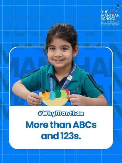 Our learning goes beyond just ABCs and 123s. A smiling student proudly displays her colorful caterpillar craft, a result of our hands-on, creative approach to education.