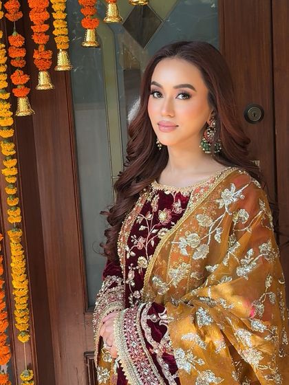 The full look, with the bride glowing in the sunlight. The makeup is kept natural and elegant, perfect for a daytime spiritual gathering.