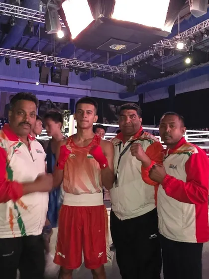 In the international arena. A moment of focus with the coaching team right before a competitive bout abroad.